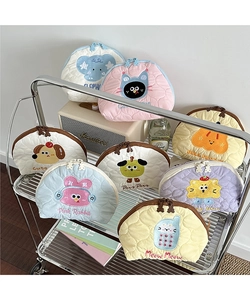 Quilted makeup bags with animal embroidery and cute cartoon zippers on a cart
