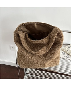 Detail of soft brown plush tote bag interior lining with internal pocket compartment