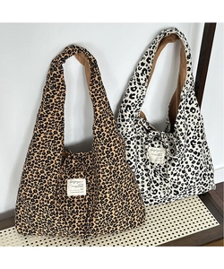 Detail view of large corduroy leopard print tote bags with vintage logo labels