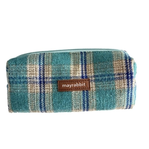 Retro plaid wool pencil case in blue and beige with a leather label on a white background