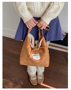 Detail of brown faux suede tote with soft fleece lining and Seeyou patch brand tag