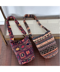 Detailed close-up of retro geometric pattern plush bucket bags on a wooden bench