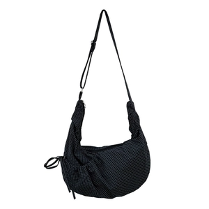 Black and white checkered crescent canvas bag with drawstring pleats and adjustable strap