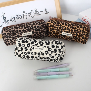 Detailed view of leopard print canvas pencil case with metal zipper and fabric label