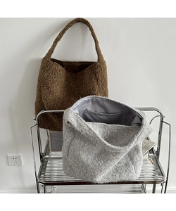 Detail of wool hobo bucket bags showing plush texture and spacious inner lining with pocket