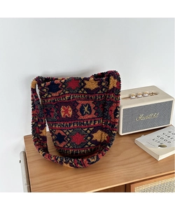 Detail of plush ethnic geometric pattern tote bag in a cozy home setting decor