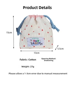 Detailed view of white cotton drawstring bag with red hearts and 15x13x5.5cm dimensions