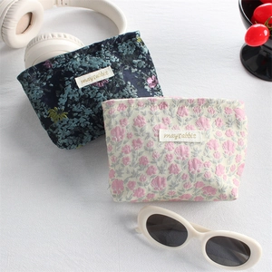 Floral canvas lipstick pouches with headphone and sunglasses in a lifestyle setup