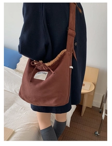 Brown faux suede crossbody bag with lamb wool trim and SEEYOU text detail