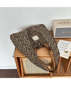 Detailed view of leopard print corduroy tote bag showing interior lining and white tag