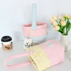 Pastel quilted puff cloud handbag with cute plush dog pendant in a bright lifestyle setting