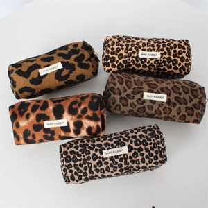 Set of five vintage leopard print makeup bags with zipper closure and logo label