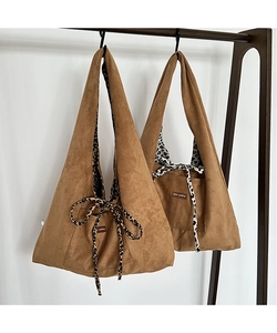 Close-up of vintage corduroy leopard tote bags in two sizes with ribbon tie closure
