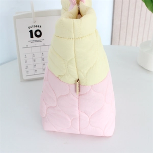 Detail of quilted puffy bag featuring contrast pink and yellow stitching texture