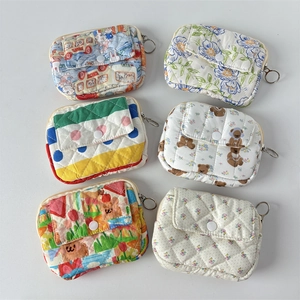 Close-up of quilted floral card holders in six patterns with metal keyrings and snaps