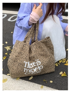 Detail of leopard print canvas tote bag with lettering on a seasonal autumn background