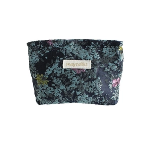 Floral canvas storage bag with vintage patterns and brand label on white background