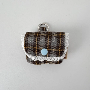 Close-up of grey plaid headphone case with lace trim and blue button decorative detail