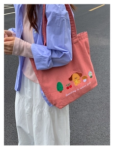 Close-up of pink denim tote bag with cute cartoon embroidery and nature park text