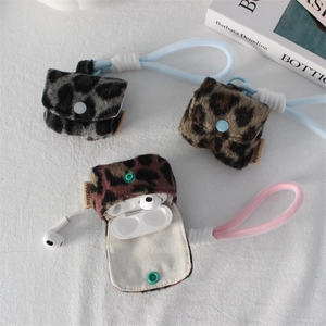 Macro shot of plush leopard print headphone cases with metal snap and braided lanyard