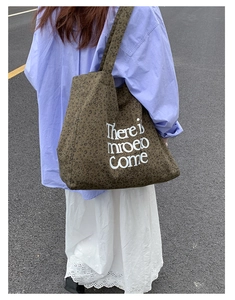 Detail of leopard print canvas tote bag featuring white letter slogan and large capacity