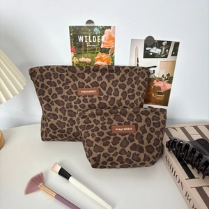 Set of two leopard print suede cosmetic bags in different sizes with zipper closure