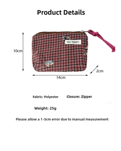Detail view of red and black plaid canvas pouch with zipper and dimensions display