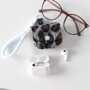 Detail of plush pink leopard print earphone case with a blue lanyard strap