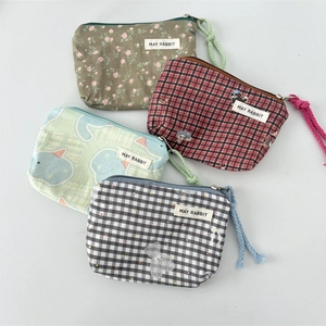 Detail of four colorful canvas mini pouches with zipper closure and wristlet straps