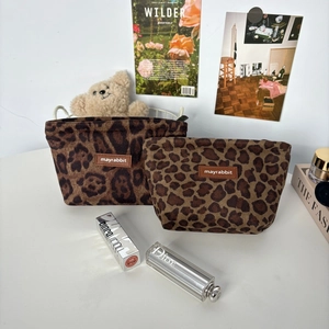 Detail of leopard print suede makeup bag set with premium leather brand label