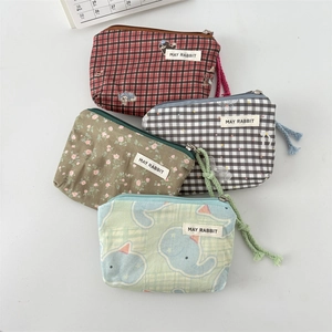 Detail of canvas mini pouches with zipper closure and floral pattern for cosmetics
