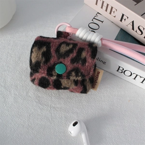 Detailed plush pink leopard print earphone case with a woven strap and green buckle