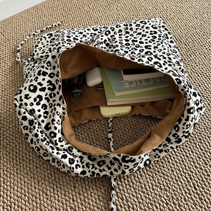 Retro leopard print corduroy tote bag showing large capacity for books and accessories