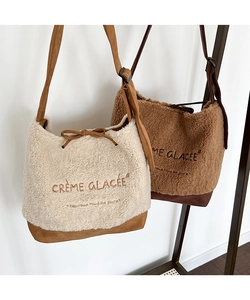 Detail of suede fleece tote bag with Crème Glacée embroidery and bow drawstring closure