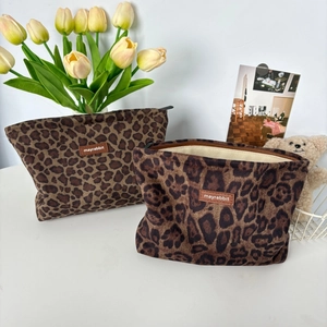 Retro leopard print suede makeup bag with a leather logo patch and metal zipper
