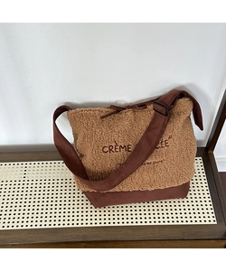 Detail of soft shearling fabric texture and Crème Brûlée embroidery on crossbody bag
