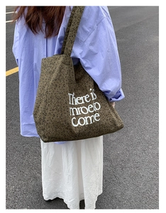 Outdoor street style shot of large leopard print canvas tote bag on model shoulder