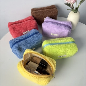 Close-up of soft plush pencil cases in six colors with interior storage detail