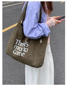Detailed view of leopard print canvas tote bag with white lettering on casual shoulder bag