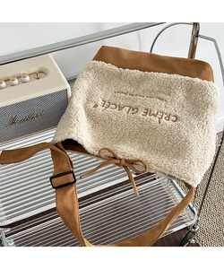 Detail of suede crossbody bag with Crème Glacée embroidery and lamb wool splicing