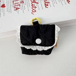 Detailed shot of quilted black earphone pouch with white lace trim and metal clip