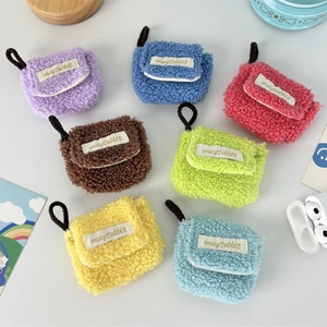 Flat lay of colorful plush AirPods cases in seven colors with mayrabbit labels