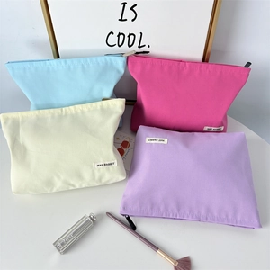 Minimalist thick canvas cosmetic bag in four vibrant colors with secure zipper closure