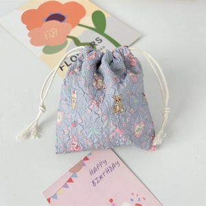 Macro view of purple seersucker drawstring bag with cute teddy bear and bunny prints