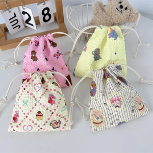 Close-up of four colorful drawstring pouches with cute cartoon bear and bunny patterns