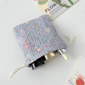 Macro view of lavender quilted drawstring pouch with cartoon bear and floral patterns