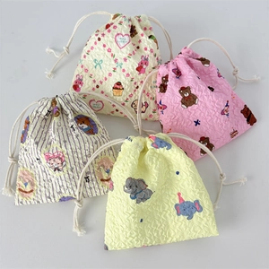 Detailed close-up of four puff print drawstring bags with cute animal patterns
