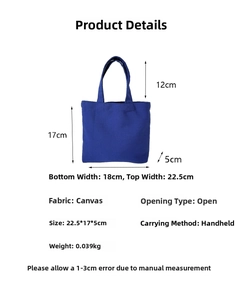 Detail view of navy canvas tote bag with dimensions 22.5x17x5cm and handle height 12cm