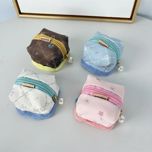 Floral fabric mini storage pouches with pearl zippers in blue, pink, beige, and brown
