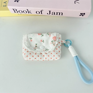 Detailed view of floral storage bag with lace trim, snap closure and blue lanyard
